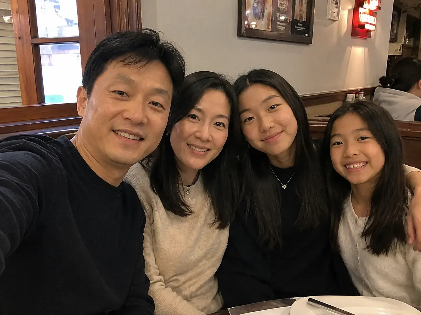 Andrew and Mina Choi together with their two daughters.
